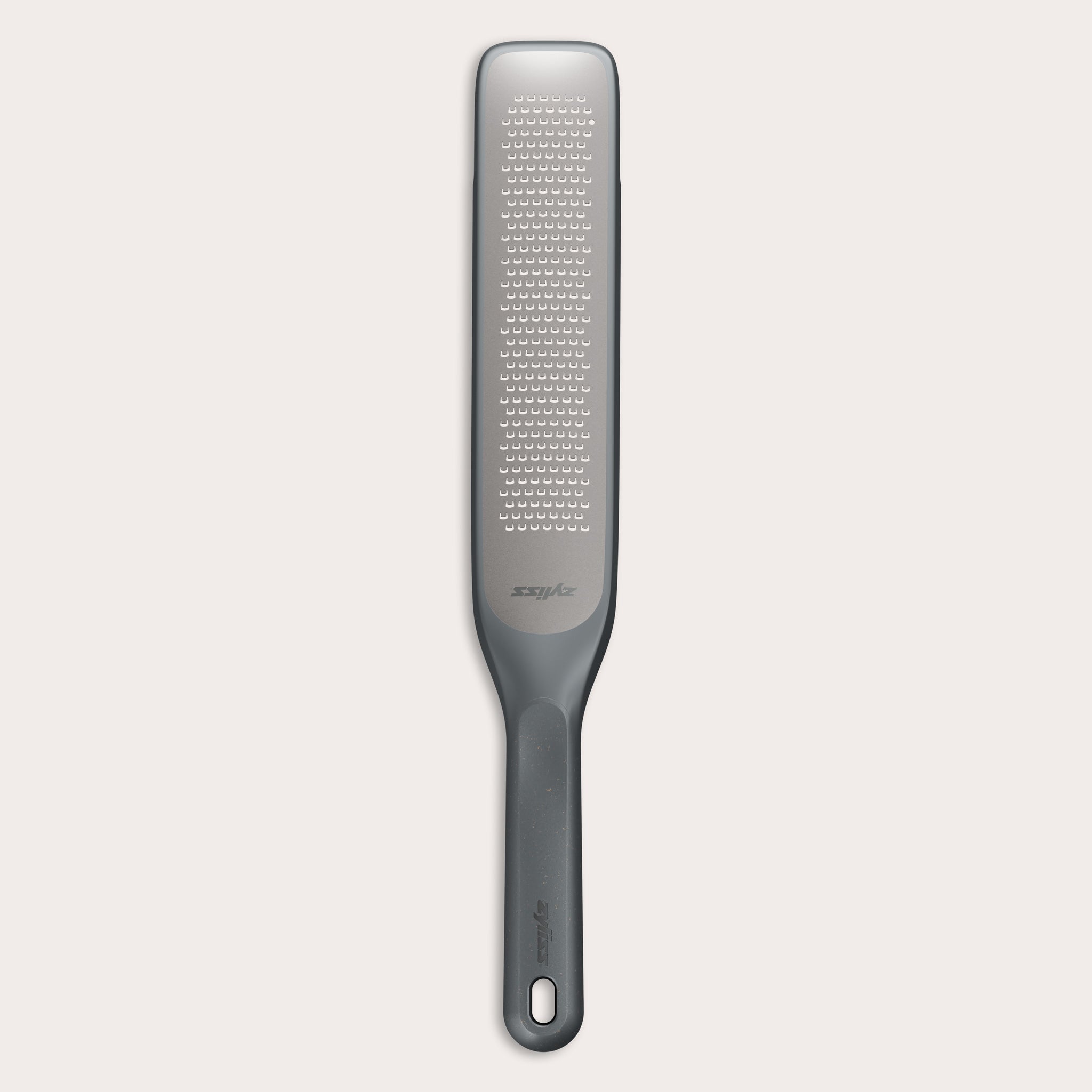 #belugagrey The Zyliss Rasp Grater is a long, rectangular foot file with a gray handle and textured metal surface for removing calluses and dead skin. The handle features a hanging hole for easy storage.