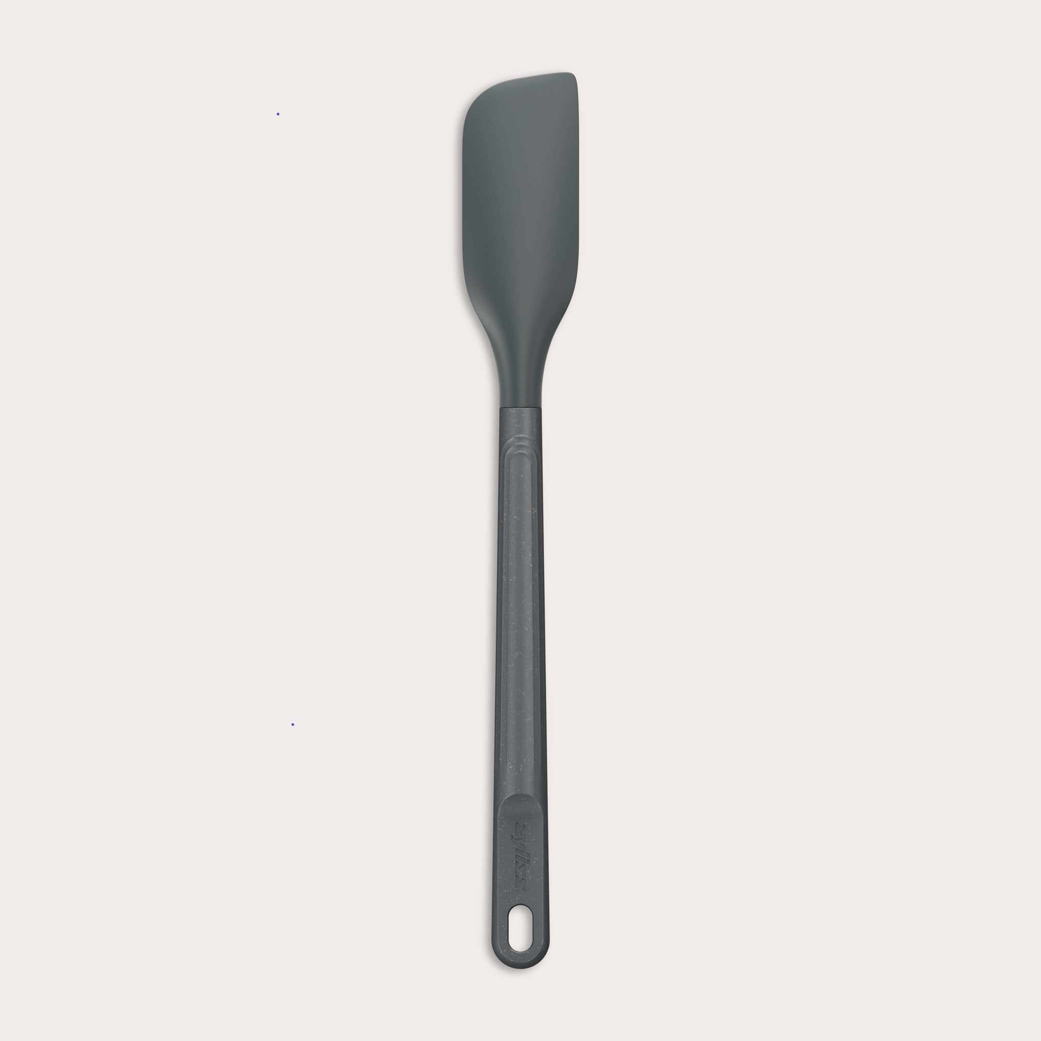 The Zyliss Spatula, featuring a long handle and flat, angled grey silicone head, is displayed against a plain white background.