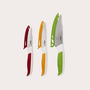 The Zyliss Comfort 3 Piece Knife Set features three kitchen knives with white ergonomic handles and colored grips—red, orange, and green—that match their protective sheaths, all displayed upright on a light background. 