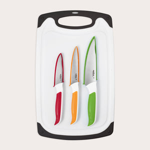 The Zyliss 4 Piece Comfort Board and Knife Set features a white board with black edges, holding three dishwasher-safe Japanese stainless steel knives with colored handles in red, orange, and green arranged from smallest to largest. 