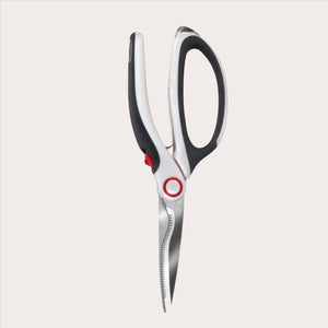 The Zyliss All Purpose Shears, featuring black and white handles and sharp, serrated stainless steel blades, are shown open on a plain white background. 