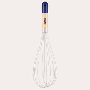The Zyliss Beech Wood Balloon Whisk has stainless steel wires, a beech wood handle with a blue tip, small hanging hole, and printed logo. Shown on a plain white background. 