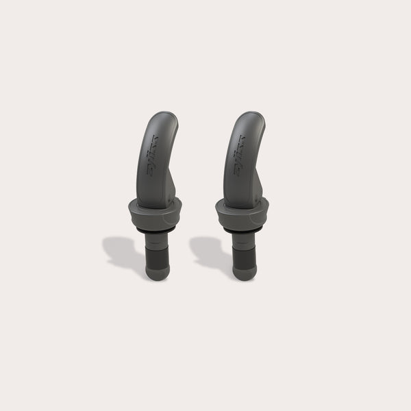 Two black, curved Zyliss Bottle Stopper 2 Piece Set items with a matte finish are displayed upright on a light beige background, featuring sleek designs that resemble wireless earbuds and small brand markings on their surfaces.