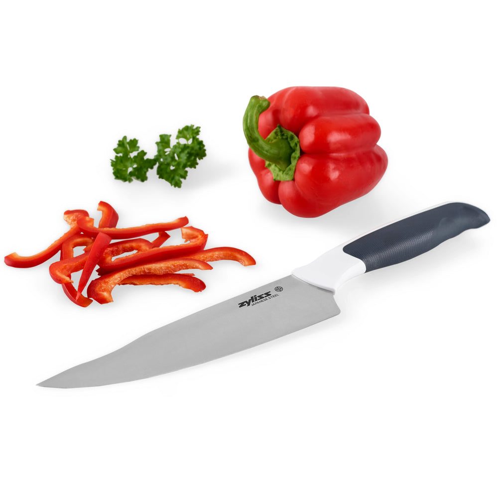 The Zyliss Comfort Chefs Knife 18.5cm / 7¼ with an ergonomic handle and stainless steel blade is displayed next to a black blade cover on a plain light background. 
