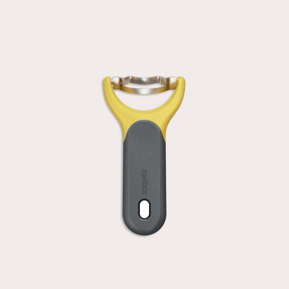 The Zyliss Corn Stripper, featuring a yellow and gray ergonomic handle and wide horizontal stainless steel blade for easy kernel removal, is shown on a plain white background. 