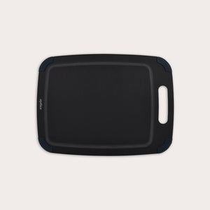 The Zyliss Wood Fibre Cutting Board is a rectangular, black, eco-friendly board with rounded corners, groove edging, right-side handle cutout, and dark blue corner accents. Made from recycled wood fibres. Shown on a plain white background. #Medium