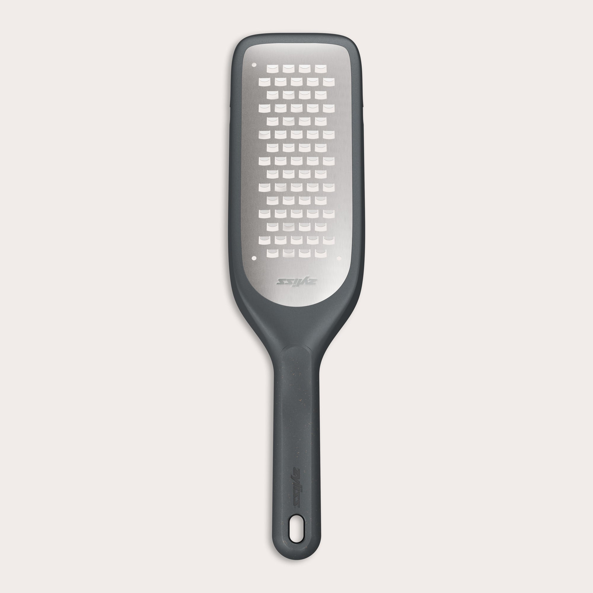 The Zyliss Coarse Grater is a black and silver foot file with a long handle and ultra-sharp grater surface, designed to efficiently remove dead skin from feet.