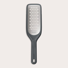 The Zyliss Coarse Grater is a black and silver foot file with a long handle and ultra-sharp grater surface, designed to efficiently remove dead skin from feet. 