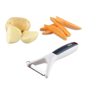 The Zyliss Smooth Glide Y-Peeler with an ergonomic handle and sharp stainless steel blade is shown beside cut pieces of potato and sweet potato on a white background. 