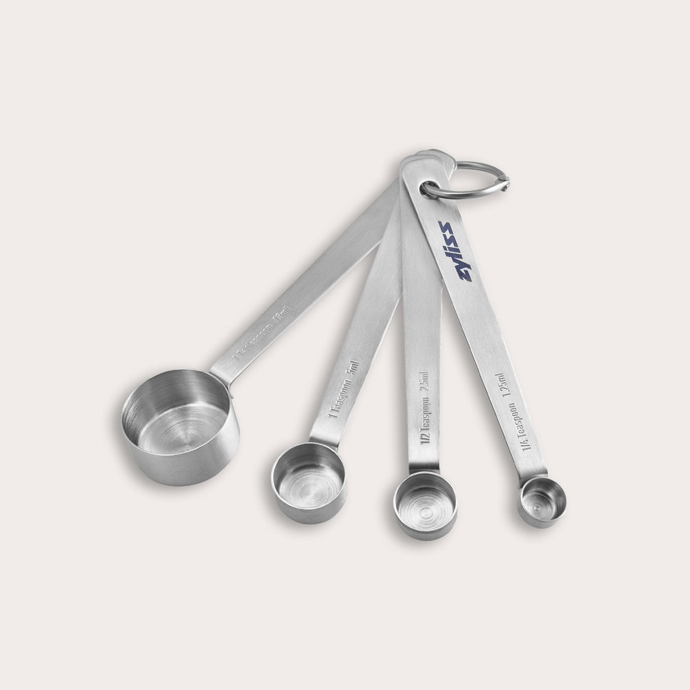 The Zyliss Stainless Steel Measuring Spoons set includes four essential kitchen tools, connected by a metal ring and shown on a plain light background. 