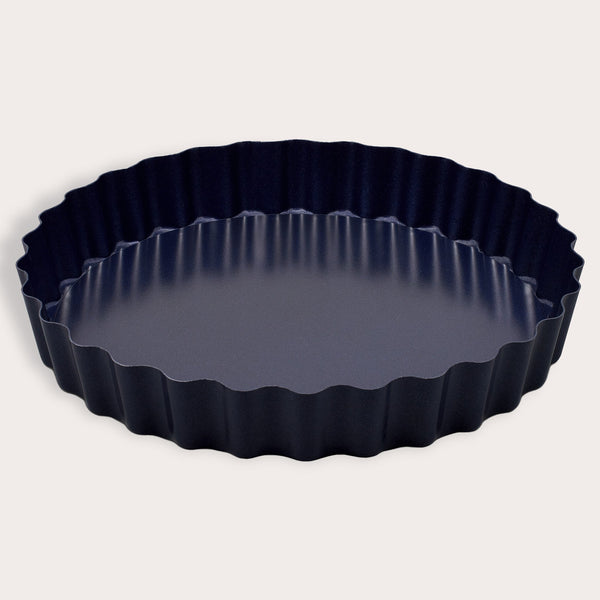 The Zyliss Durable Non-Stick Tart Pan, made from strong carbon steel with fluted edges and a non-stick coating, is shown on a plain light background—ideal for baking tarts or quiches.