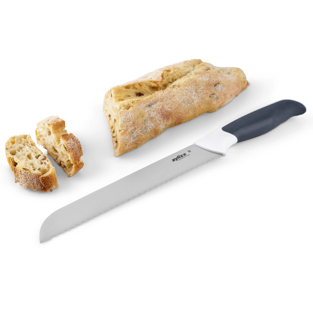 The Zyliss Comfort Bread Knife 20.5cm/8 with a stainless steel serrated blade and ergonomic handle is shown beside its black sheath, all set against a plain white background. 