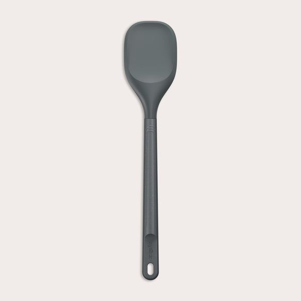 #large A Zyliss Spoontula with a dark gray, rounded silicone head and a long ergonomic handle, featuring a small hanging hole near the end, is displayed against a light background. #Large