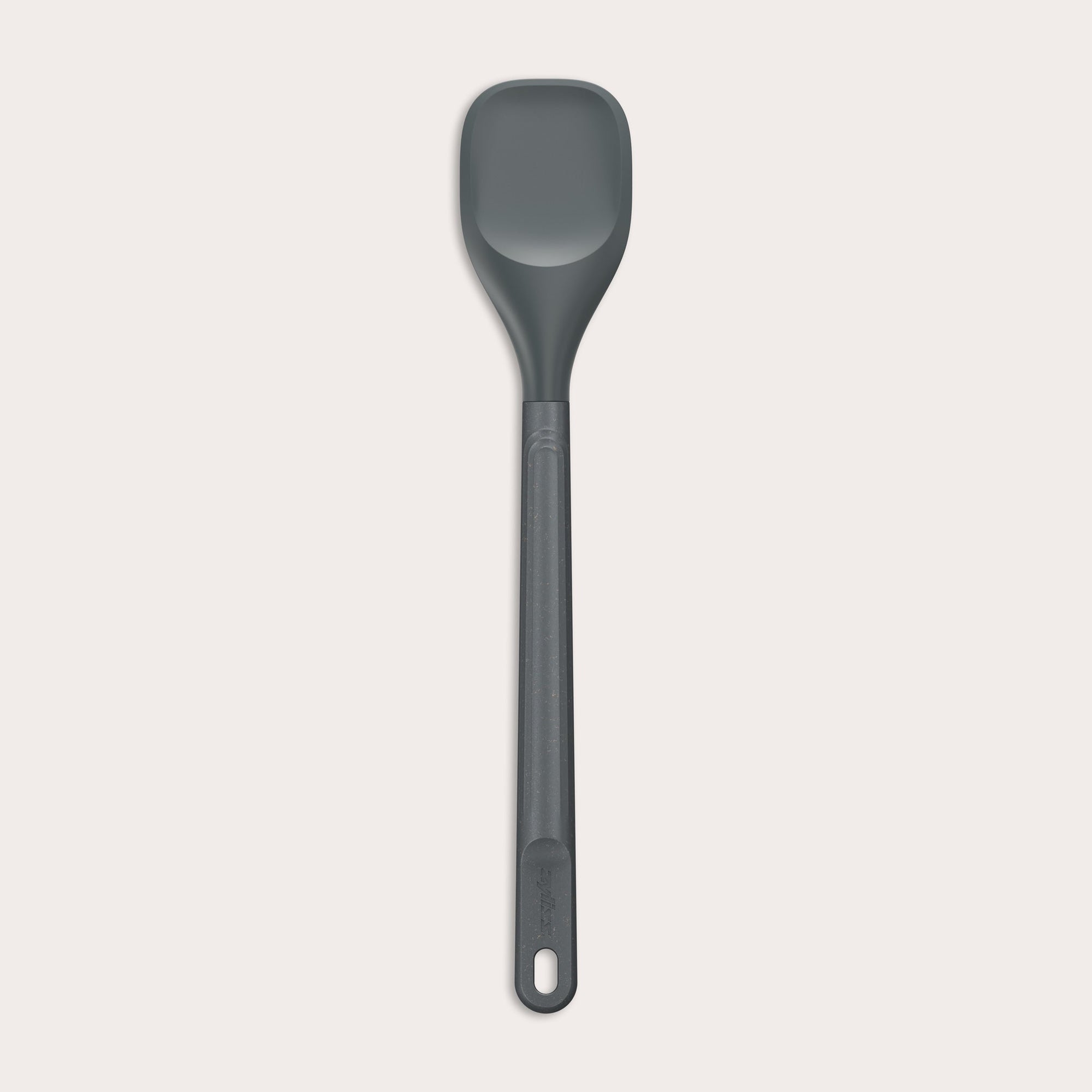 #medium The Zyliss Spoontula is dark gray, with a silicone head, long ergonomic handle, and a gently rounded rectangular bowl, pictured on a plain light background. #Medium
