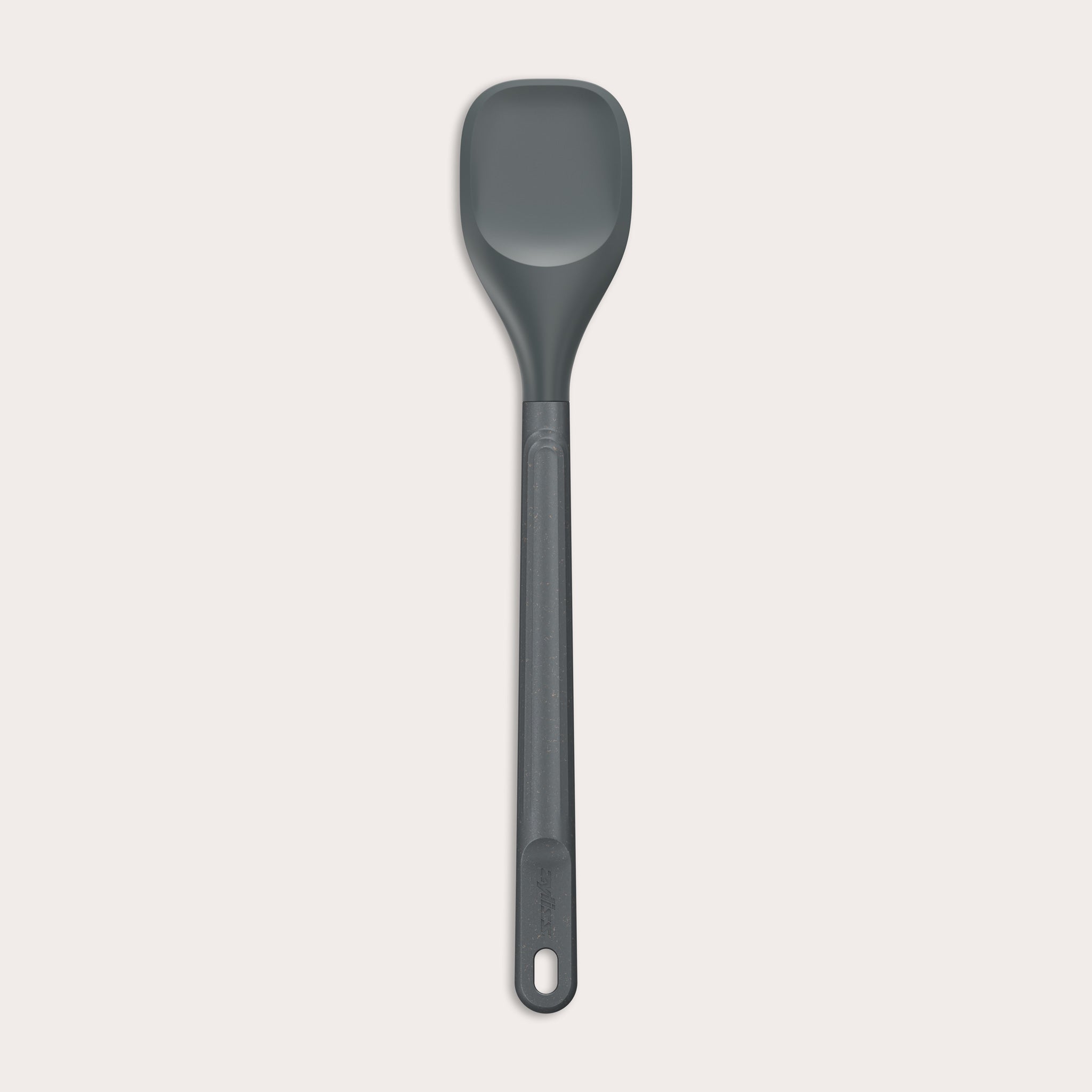 #medium The Zyliss Spoontula is dark gray, with a silicone head, long ergonomic handle, and a gently rounded rectangular bowl, pictured on a plain light background. #Medium