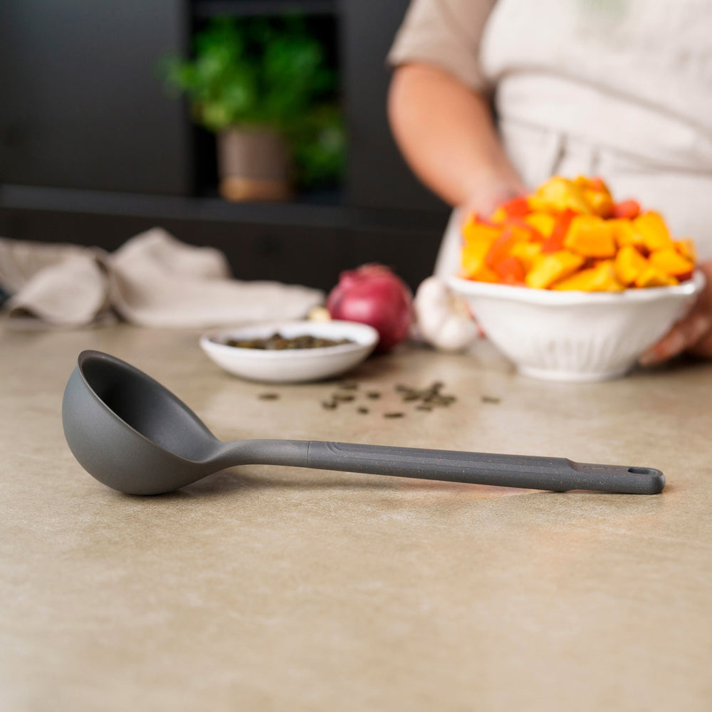 #medium A Zyliss Ladle in black with a long handle and deep, rounded bowl is displayed against a plain white background. #Medium