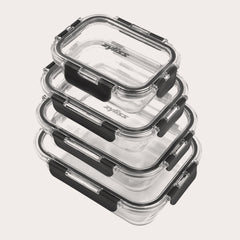 The Zyliss 4-Piece Glass Container Set features clear borosilicate containers with black locking lids, stacked neatly for leak-proof food storage against a plain white background. 
