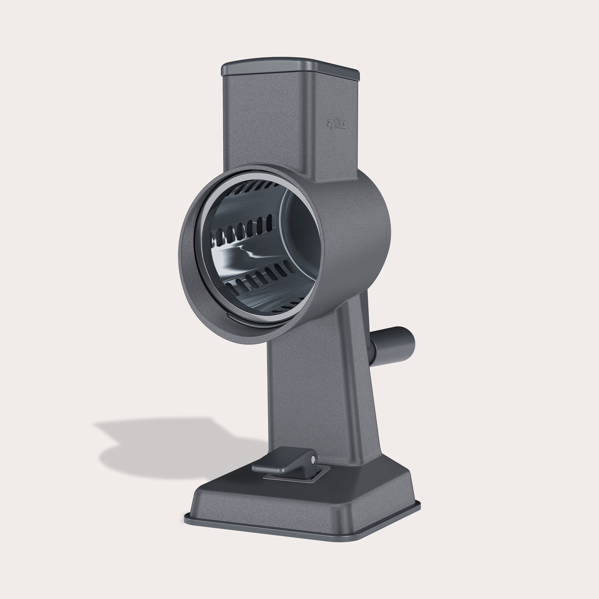 #drumgratersingle The Zyliss Gourmet Drum Grater, featuring a sturdy gray stainless steel design with handle and base, stands upright on a light background, highlighting its cylindrical grating drum.