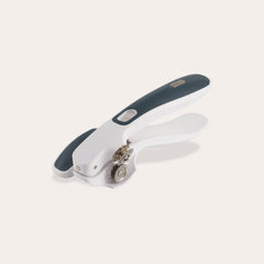 The Zyliss Lock & Lift Can Opener, shown on a plain light background, features white and dark gray colors, a large ergonomic handle, locking mechanism, and rotating cutting wheel. 