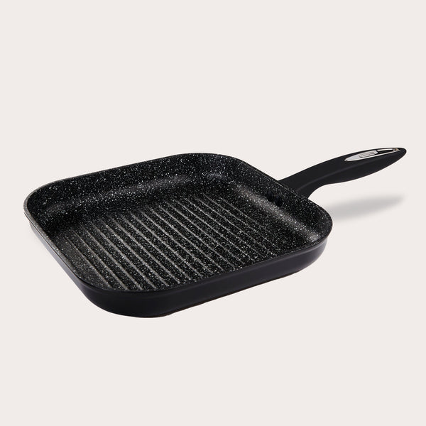 The Zyliss Ultimate Non-Stick Grill Pan is black, square, and PFOA-free with Swiss non-stick coating, raised ridges, and a long handle. Shown on a plain light background. 