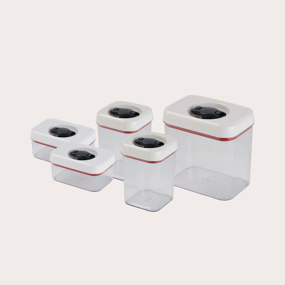 The Zyliss Twist & Seal 5 Piece Container Set features transparent plastic containers in various sizes with white twist-lock lids and black buttons, ideal for versatile kitchen storage. 