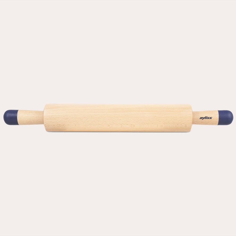 A Zyliss Beech Wood Rolling Pin with blue comfort-grip handles rests horizontally on a light background, showcasing the brand name for an essential tool in any kitchen. 