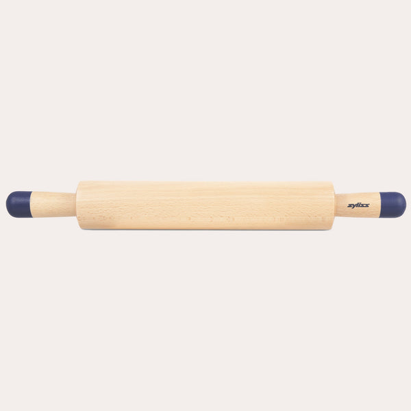 A Zyliss Beech Wood Rolling Pin with blue comfort-grip handles rests horizontally on a light background, showcasing the brand name for an essential tool in any kitchen. 