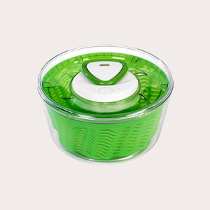 The Zyliss Easy Spin 2 Salad Spinner Small is green and transparent with a compact design, featuring a white button and handle on top, shown from above against a plain light background. 