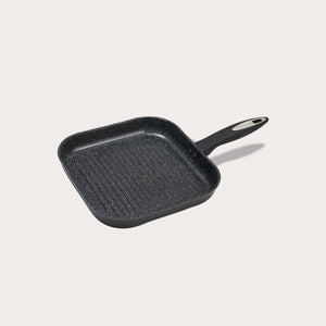 The Zyliss Ultimate Ceramic grill pan is black, square with ridges, a long handle, and a non-stick coating, shown on a plain light background.