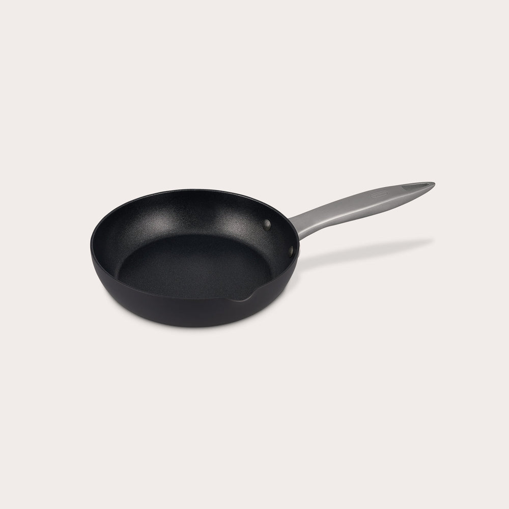 The Zyliss Ultimate Pro Non-Stick Frying Pan With Pouring Lip features a black, Swiss-coated hard-anodized aluminum body and a long gray handle, shown on a plain white background. #20cm/8"