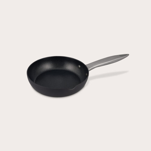 The Zyliss Ultimate Pro Non-Stick Frying Pan With Pouring Lip features a black, Swiss-coated hard-anodized aluminum body and a long gray handle, shown on a plain white background. #20cm/8"