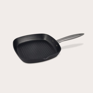 The Zyliss Ultimate Pro Non-Stick Square Grill Pan With Pouring Lip, black with raised ridges and a long silver handle, made from hard-anodized aluminium, is set against a plain light background. 