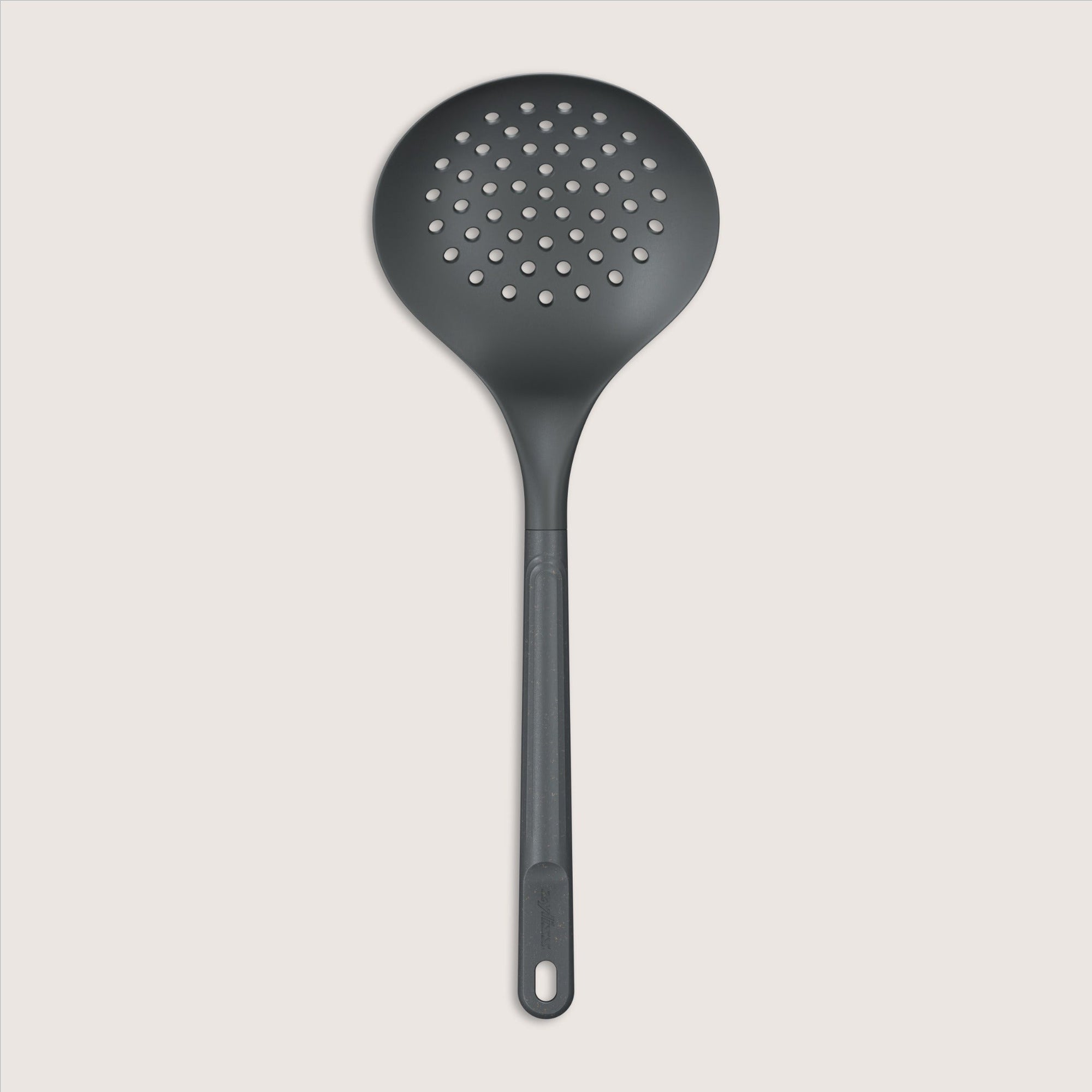 A black slotted spoon with a round, perforated head and a long handle, displayed against a plain light background.