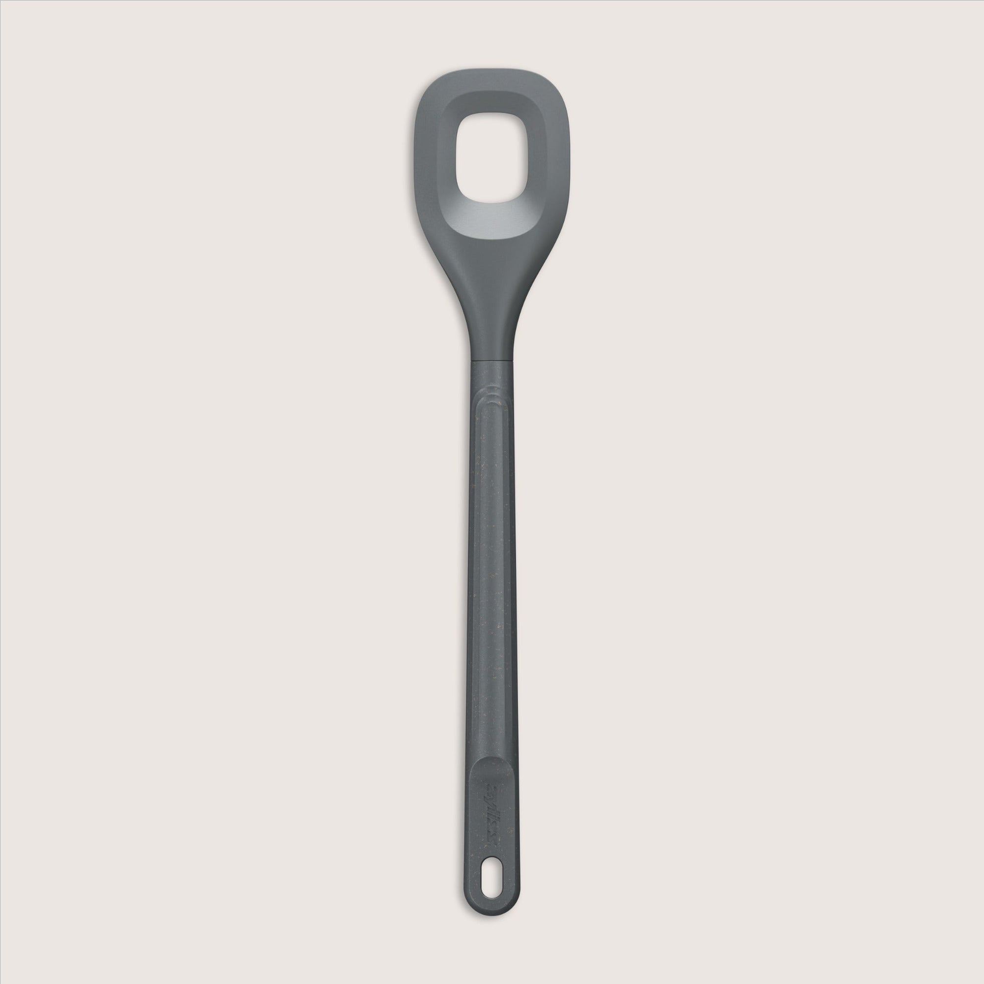 A gray silicone spoon with a rectangular hole in the center of the head and a long handle, set against a plain, light background.