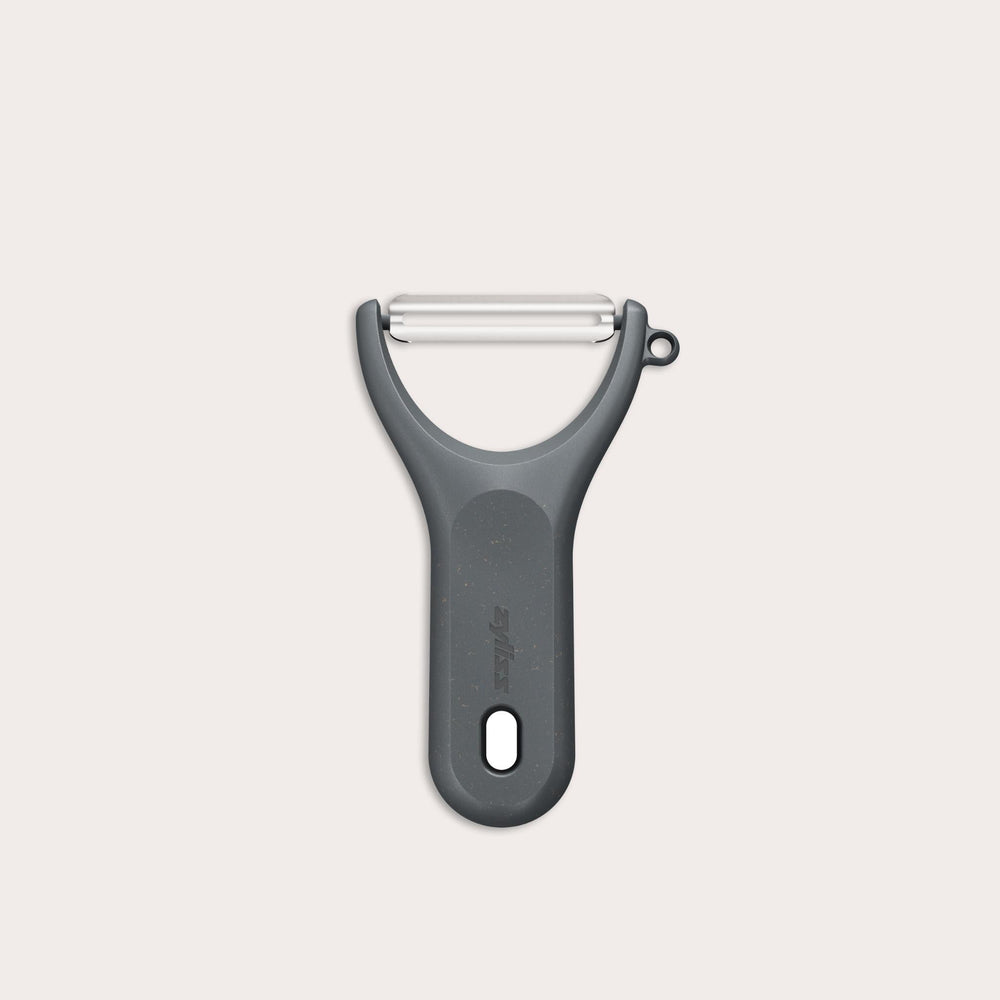 A Zyliss Y Peeler with a stainless steel swivel blade, ergonomic handle, and end hole is shown in black on a plain white background. 