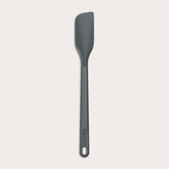 The Zyliss Spatula, featuring a long handle and flat, angled grey silicone head, is displayed against a plain white background.
