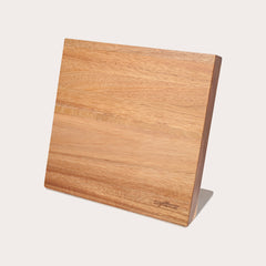The Zyliss Comfort Pro Magnetic Knife Block features a simple, angled rectangular wooden design with a metal base, offering space-saving and stylish kitchen knife storage, shown against a plain white background. 