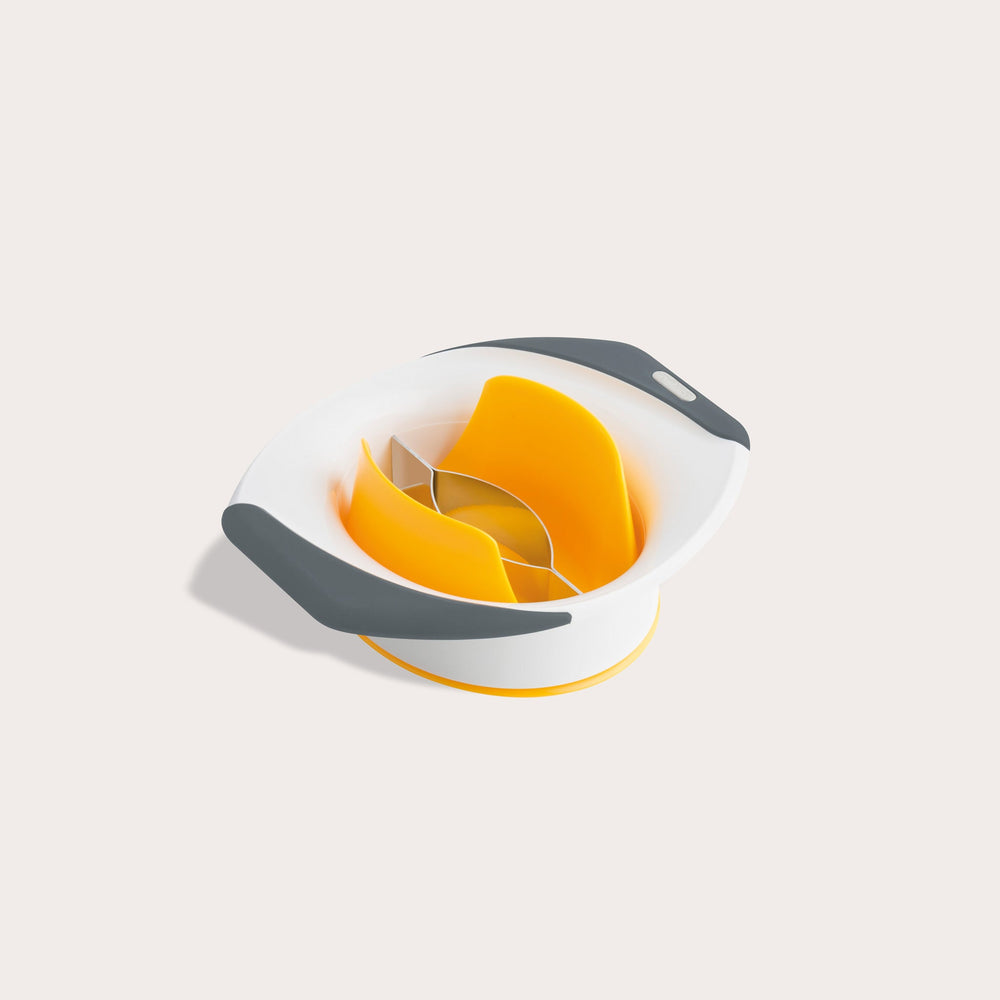 A yellow and white Zyliss Mango Splitter with non-slip handles and stainless steel blades, designed for easily slicing and coring mangoes, is shown on a light background. 