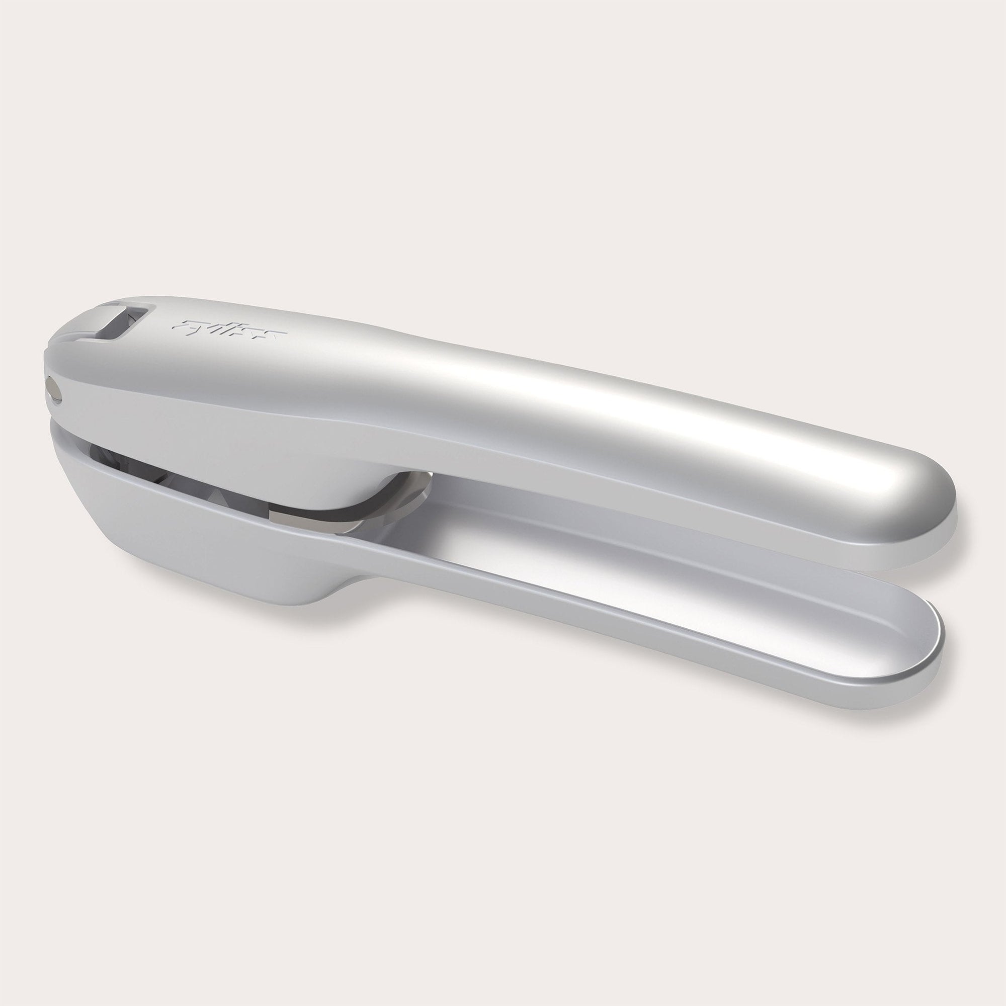 The Zyliss Susi 4 Garlic Press by Zyliss features ergonomic handles and a curved design in silver, shown on a light gray background for easy cleanup.